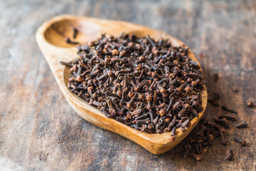 Dried clove seeds in a wooden bowl