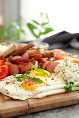 bruschetta with tomato, sausages and eggs