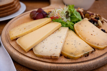 Cheese board with variety of hard Belgian cheeses made in trappist abbey