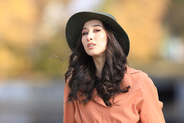 autumn portrait of a beautiful asian brunette woman in a fashionable hat