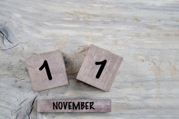cube calendar for november on wooden background with copy space