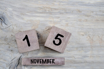 cube calendar for november on wooden background with copy space