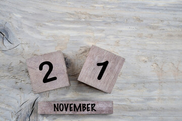 cube calendar for november on wooden background with copy space