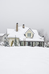 a private house and its garden under snow in winter