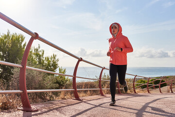 Muslim woman wears a hijab while running