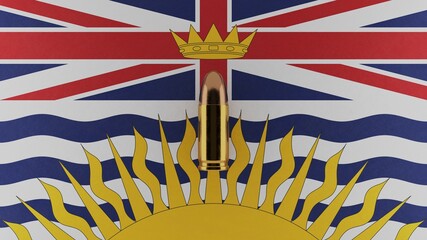 Top down view of a 9mm bullet in the center and on top of the flag of British Columbia