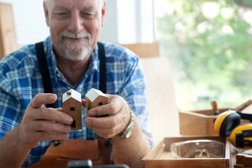 Caucasian craftsman smiled proudly at the woodwork in his hand, DIY concept