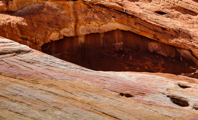 Orange rock faces and pink and white plateaus in the Nevada Desert