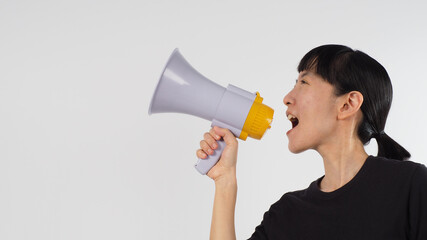 Asian woman hand is holding megaphone and wear black t shirt on white background..