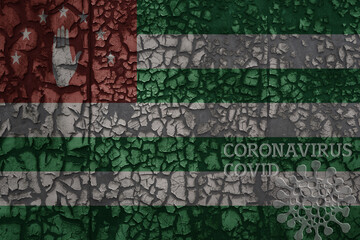 flag of abkhazia on a old metal rusty cracked wall with text coronavirus, covid, and virus picture.