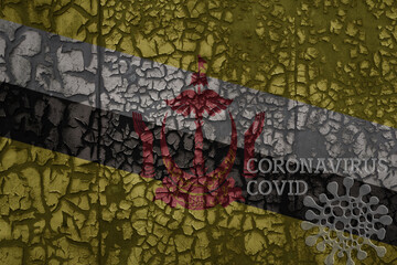 flag of brunei on a old metal rusty cracked wall with text coronavirus, covid, and virus picture.