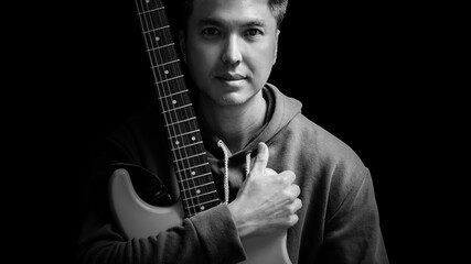 black and white portrait of young asian handsome guitarist, artist, composer, pop rocker star....