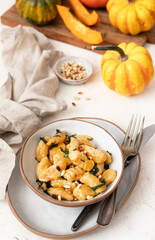 Autumn dish Pumpkin gnocchi with butter, pine nuts and spinach	