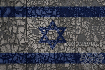 flag of israel on a old metal rusty cracked wall with text coronavirus, covid, and virus picture.