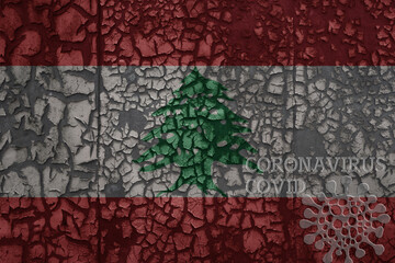 flag of lebanon on a old metal rusty cracked wall with text coronavirus, covid, and virus picture.