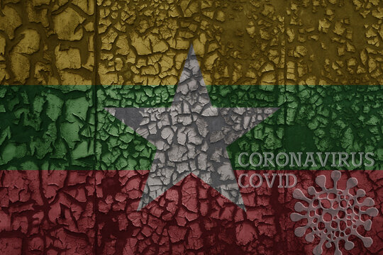 Flag Of Myanmar On A Old Metal Rusty Cracked Wall With Text Coronavirus, Covid, And Virus Picture.