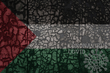 flag of palestine on a old metal rusty cracked wall with text coronavirus, covid, and virus picture.