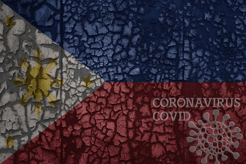 flag of philippines on a old metal rusty cracked wall with text coronavirus, covid, and virus picture.