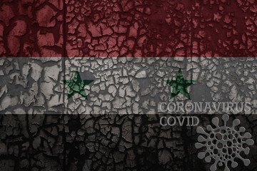 flag of syria on a old metal rusty cracked wall with text coronavirus, covid, and virus picture.