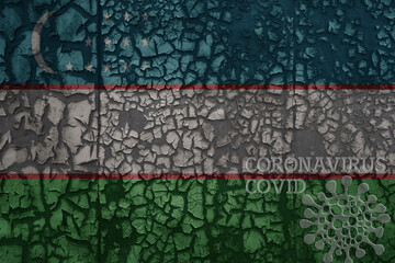 flag of uzbekistan on a old metal rusty cracked wall with text coronavirus, covid, and virus picture.