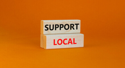Time to support local symbol. Wooden blocks with words 'Support local'. Beautiful orange background. Business and time to support local concept. Copy space.