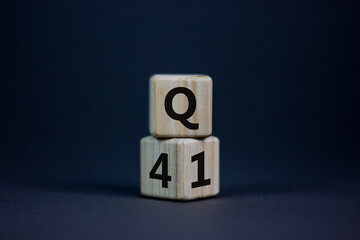 From 4th to 1st quarter symbol. Turned wooden cubes and changed words 'Q4' to 'Q1'. Beautiful grey table, grey background. Business, happy 1st quarter Q1 concept, copy space.