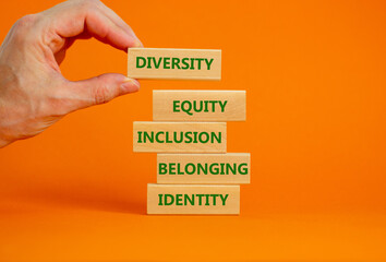 Diversity, equity, inclusion, belonging, identity symbol. Wooden blocks with words Diversity, equity, inclusion, belonging, identity on beautiful orange background. Business, Inclusion concept.