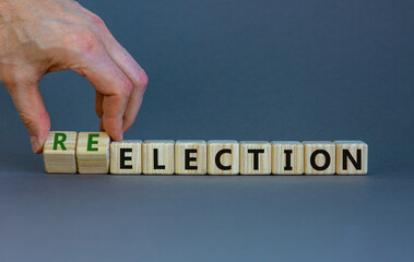 Election or reelection symbol. Wooden cubes with words 'Election reelection'. Businessman hand....