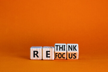 Refocus and rethink symbol. Businessman turned cubes and changed the word 'refocus' to 'rethink'....