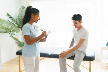 Fototapeta premium black rehabilitation woman physiotherapy at physio clinic with customer