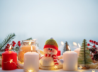 Winter Christmas holidays background with candles; christmas light; Cup of cocoa with marshmallow...