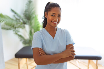 Portrait of young black woman physiotherapist on a physio center - obrazy, fototapety, plakaty