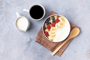 Healthy breakfast set on grey background. The concept of delicious and healthy food. Granola, coffee and milk. Top view, copy space.