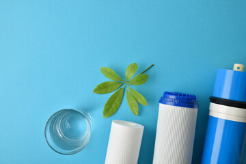 Filters and osmosis membrane with filtered water glass on blue