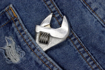 wrench in blue jeans pocket