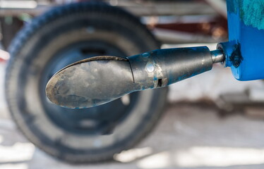 The propeller of a yacht in a folded state on the shore in close-up in summer