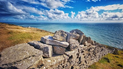 Jurassic coast, anvil point Swanage lighthouse blue sea with Dorset stone wall in Purbeck