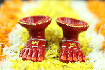 Feet Of Hindu Goddess Lakshmi Called Laxmi Charan With Diya, Deep Or Dia On Marigold Flower Rangoli. Theme For Shubh Deepawali And Laxmi Pooja