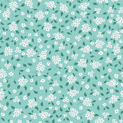 Seamless floral pattern. Pretty, small white flowers on a light green background. Ditsy print. Blossoming meadow. Vector illustration.