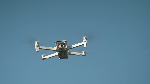 White Drone Hanging in Air or Flying on Nature Background 4K Shot