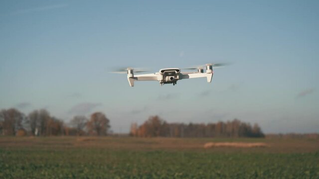 White Drone Hanging in Air or Flying on Nature Background 4K Shot