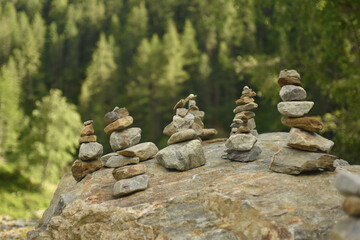 Selective focus of stacked rocks on a bigger rock in the forest