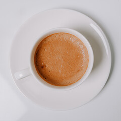 Square photo of a cup of coffee on white background.