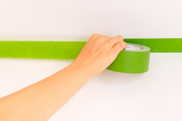 Applaying masking tape to the wall
