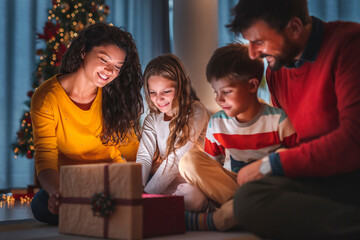 Parents and children opening Christmas presents