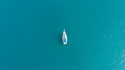 Minimalism. View from the height of a white yacht in the blue sea.