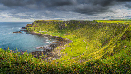 Panorama of Giants Causeway with dramatic light and sky, seen from top of the cliff, Wild Atlantic...