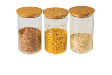 Close up view of glass jars with cereals and pasta isolated on  white  background. Kitchen and healthy food concept.