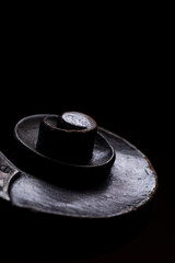 The scroll of an acoustic wood double bass on a black background