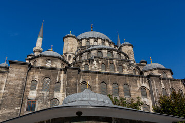 Fototapeta na wymiar The New Mosque or Yeni Cami located on the Golden Horn embankment in the Eminonu district of Istanbul, Turkey. It is one of the best-known sights of Istanbul.